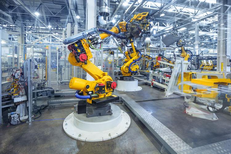 What are the uses of industrial robots in automated production lines?
